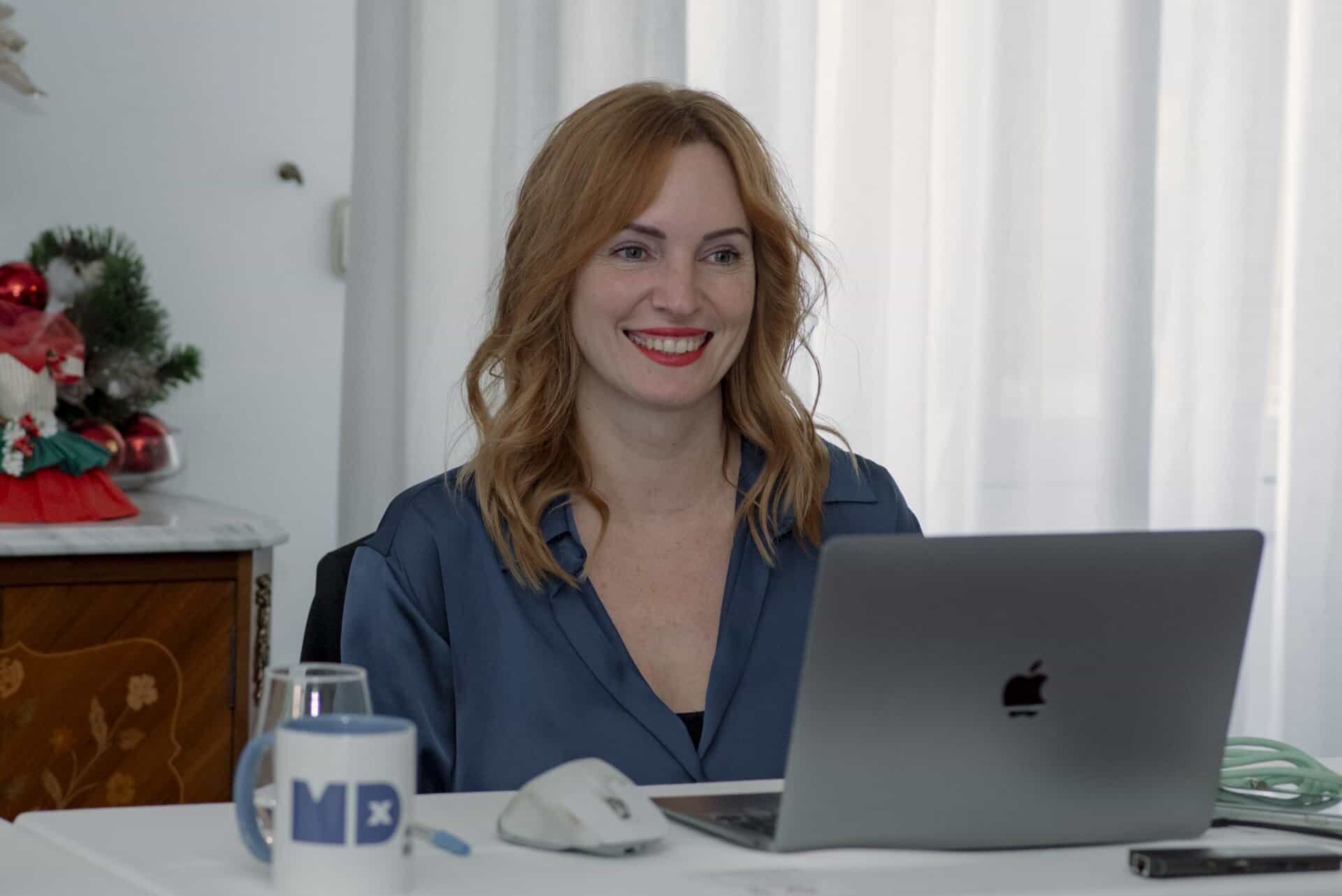Innovative MDX medical technology at work with a smiling woman healthcare professional during an online meeting. Focus on advancing MedTech solutions and digital health innovation.