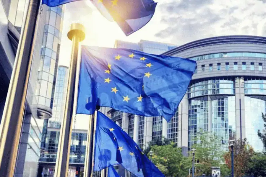 EU flags flying in front of a modern office building, symbolizing European MedTech innovation and regulatory excellence.
