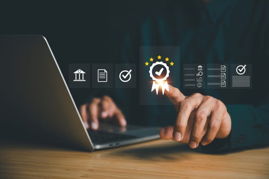 High-quality image of a person interacting with digital certification and approval icons on a laptop, emphasizing MedTech innovation, compliance, and accelerated medical technology solutions.