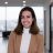 Innovative woman smiling in modern office background, representing MedTech innovation, healthcare, and technology advancement in clinical environments.