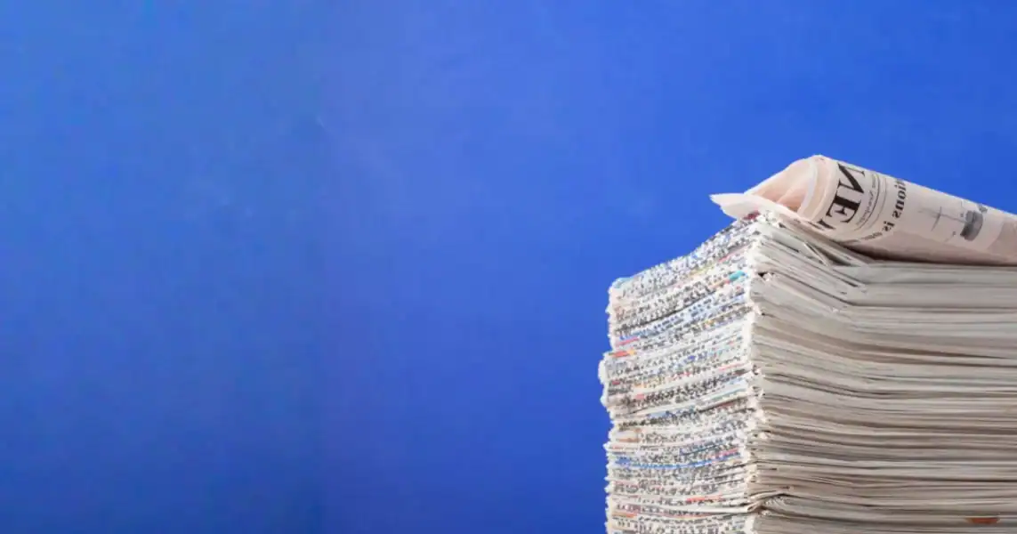 A tall stack of organized medical device documentation and regulatory papers against a blue background, emphasizing compliance and regulatory standards in MedTech.