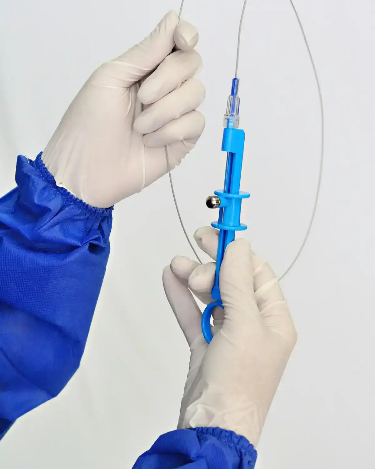 Close-up of a healthcare professional's hands preparing a medical device injection with sterile gloves and equipment.